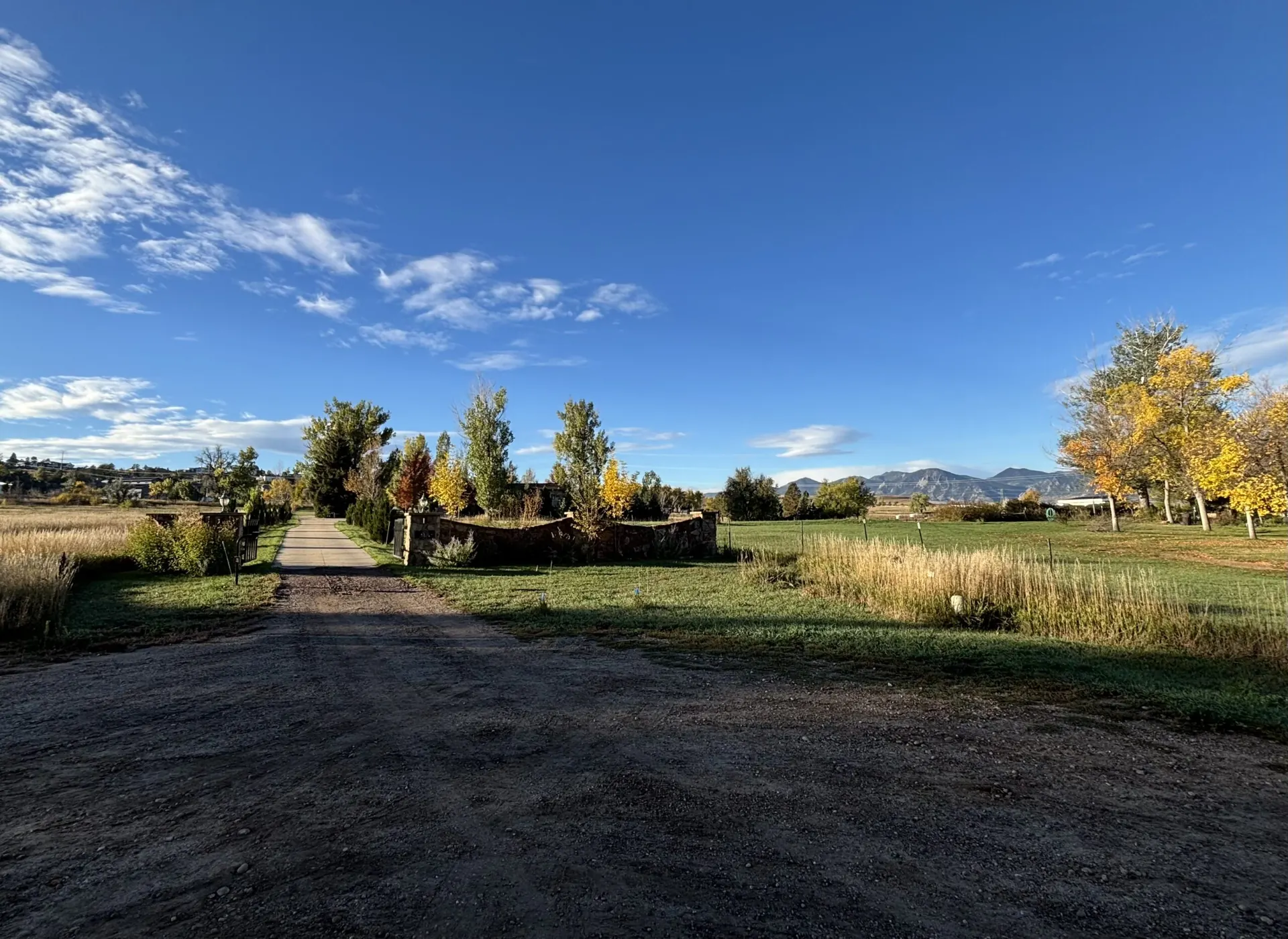 Real estate advisor handing new-home keys to clients outside a contemporary Colorado home
